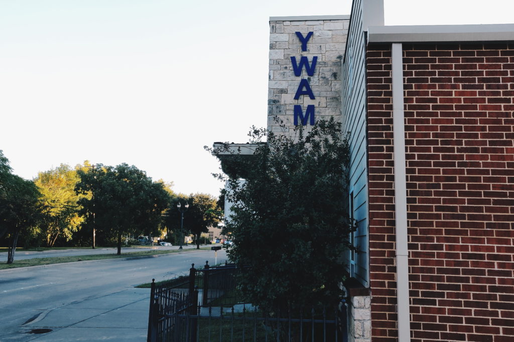 YWAM sign outside of YWAM Wylie main building in Wylie, Texas. The building is located on Ballard Avenue right next to Downtown Wylie.